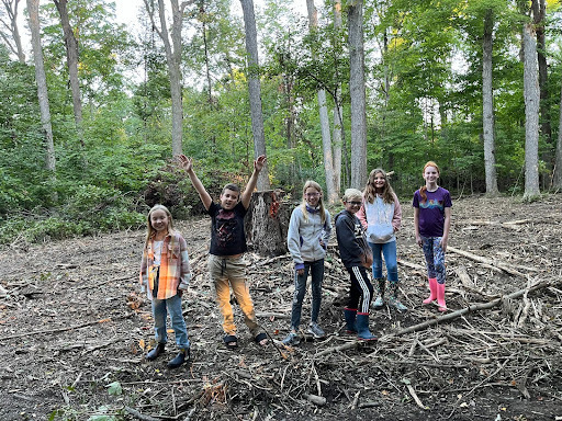 Coesse students stand in the clearing of the woods