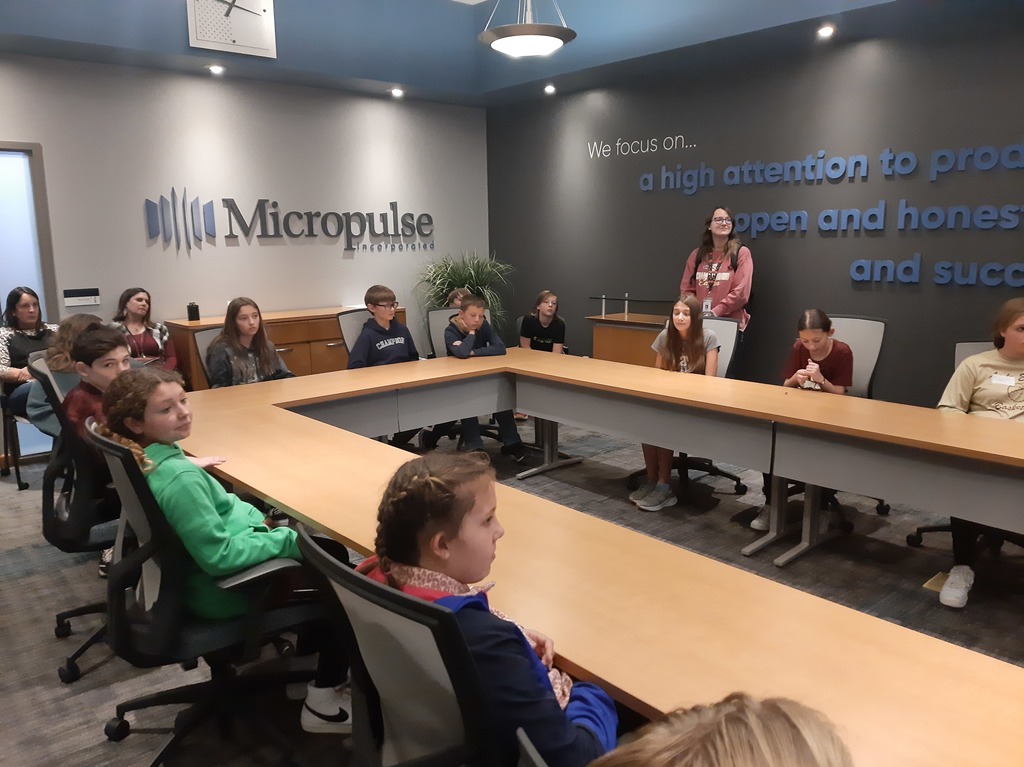 Students sit in Micropulse's conference room. 