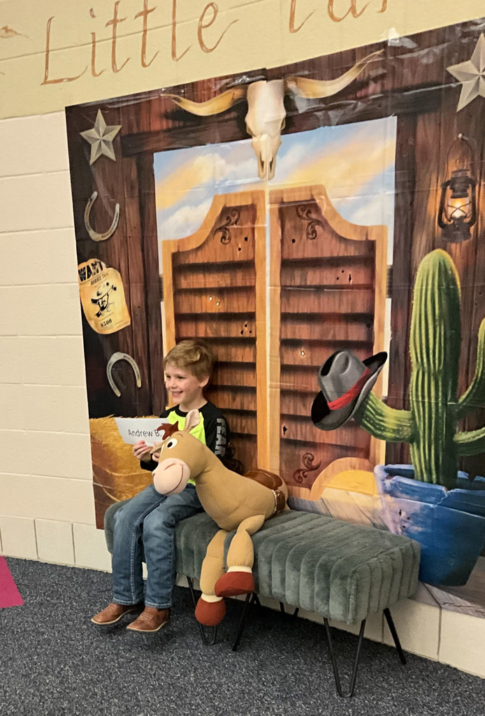 Kindergarten Round Up Student poses with Bullseye the Horse