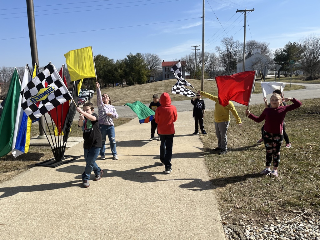 Students wave racing flags